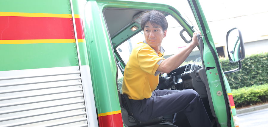 A Fukuyama Transporting employee leaving his truck.